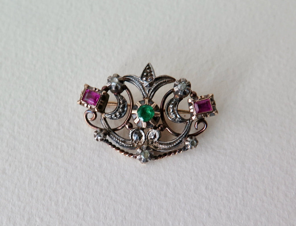 Antique brooch with table cut rubies and emerald