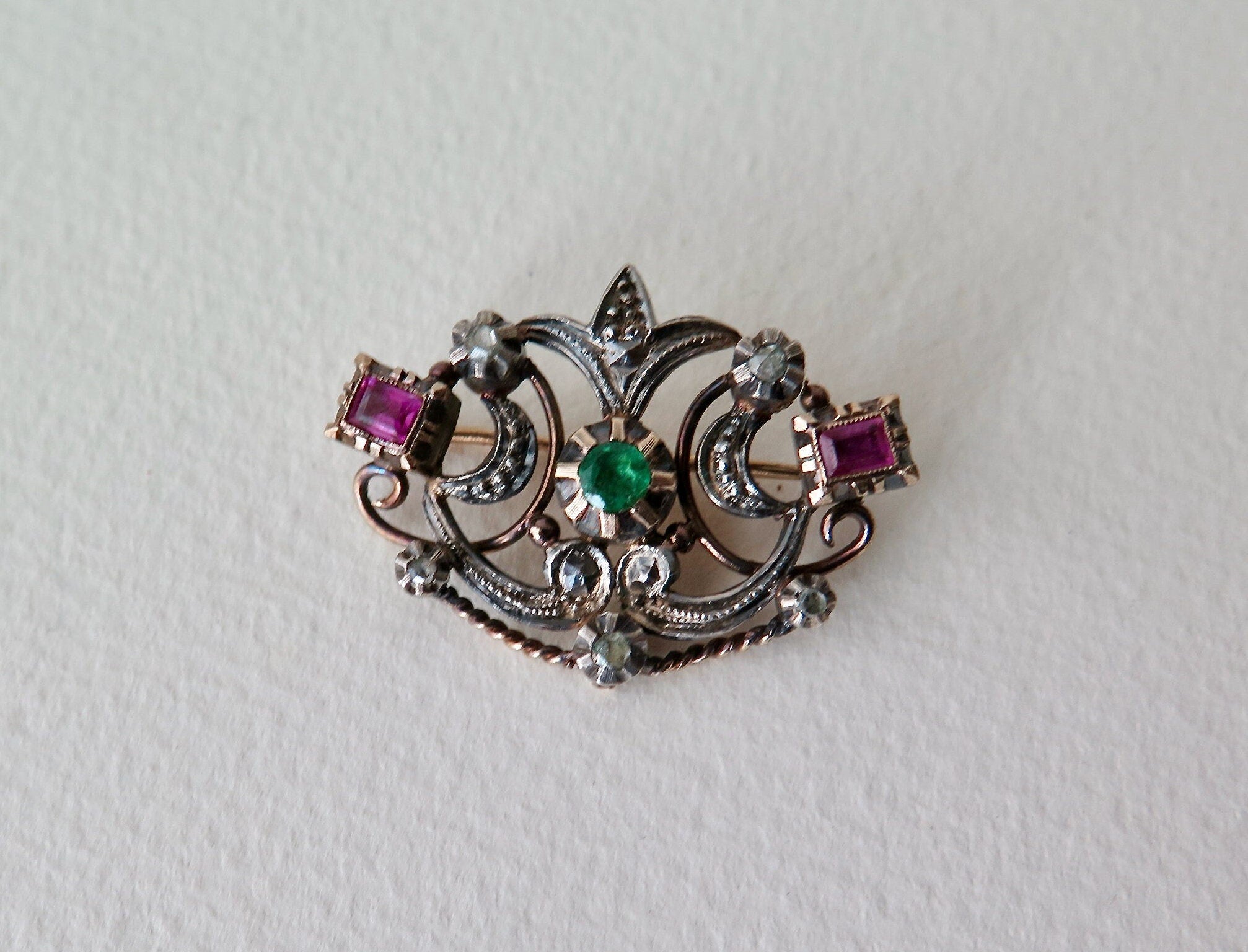 Antique brooch with table cut rubies and emerald